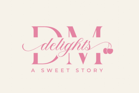 Logo for DM Delights, with the word 'delights' in the centre of the initials 'DM' in pink letters.  The words 'A SWEET STORY' are printed underneath.