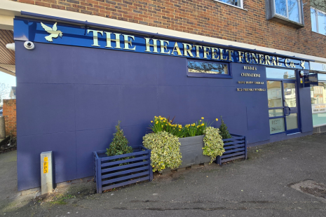 Image showing the exterior of The Heartfelt Funeral Company, painted dark blue with gold writing.