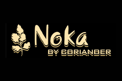 Logo for 'Noka by Coriander' in gold lettering on a black background a gold sprig of coriander.