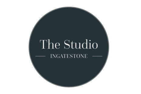 Logo for The Studio Ingatestone, with white text on a dark grey circular background.