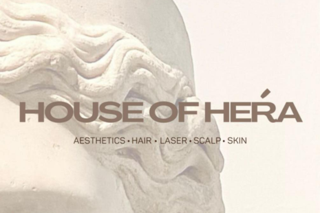 House of Hera logo - brown text on a cream background depicting a statue.