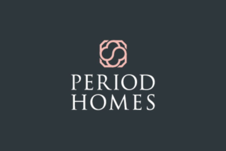 Logo for Period Homes, white text and pink icon on a dark grey background.