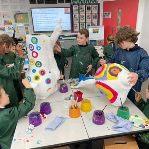Image showing school children decorating a large Easter Bunny character in pieces