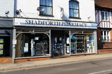 Image showing the front of the SHADFORTH PHARMACY in Ingatestone High Street. The pharmacy is the ground floor of an older style white building with black windows.